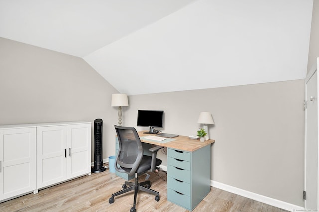 office space with light wood finished floors, lofted ceiling, and baseboards