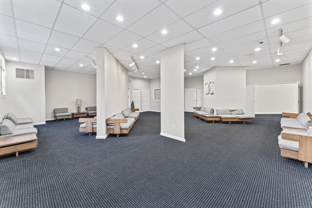 carpeted living area with baseboards and recessed lighting