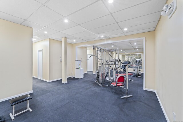 workout area with recessed lighting, baseboards, and a drop ceiling