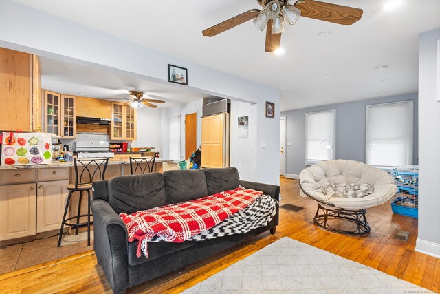77 Cedar St, Norwalk, CT 06854 - living room featuring a ceiling fan, light wood finished floors, and baseboards