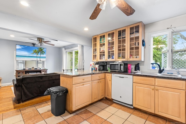 77 Cedar St, Norwalk, CT 06854 - kitchen with white dishwasher, a sink, stainless steel microwave, ceiling fan, and a peninsula
