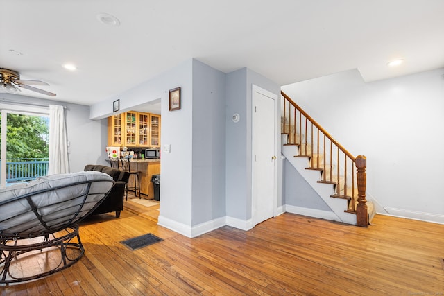77 Cedar St, Norwalk, CT 06854 - living area featuring light wood finished floors, ceiling fan, baseboards, stairs, and recessed lighting