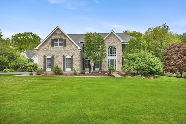 260 Range Rd, Fairfield, CT 06890 - view of front of property with a front yard, brick siding, and roof with shingles