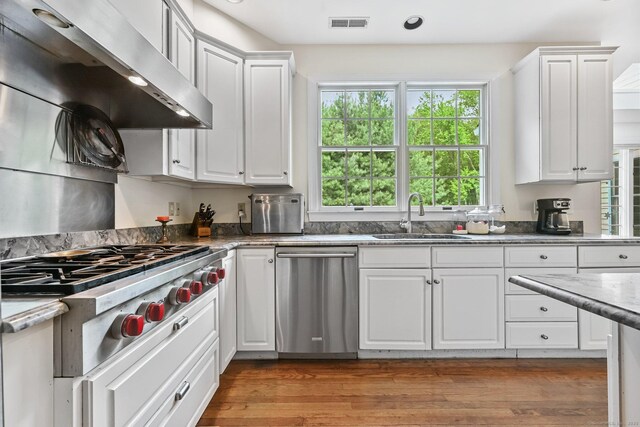 260 Range Rd, Fairfield, CT 06890 - kitchen featuring appliances with stainless steel finishes, a sink, healthy amount of natural light, wall chimney exhaust hood, and recessed lighting