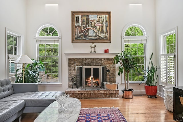 260 Range Rd, Fairfield, CT 06890 - living room featuring wood finished floors, a high ceiling, healthy amount of natural light, and a fireplace