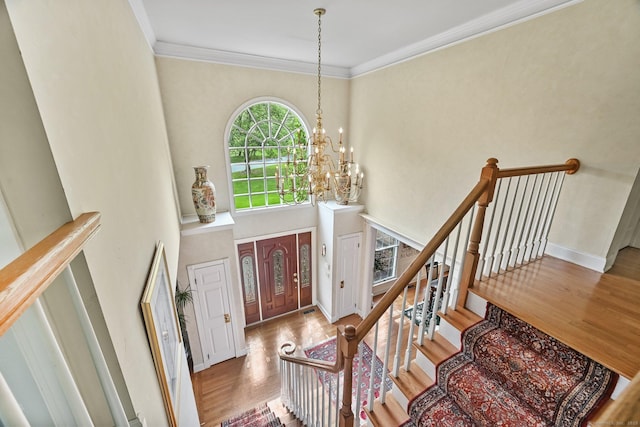 260 Range Rd, Fairfield, CT 06890 - entryway with wood finished floors, a chandelier, crown molding, baseboards, and a high ceiling