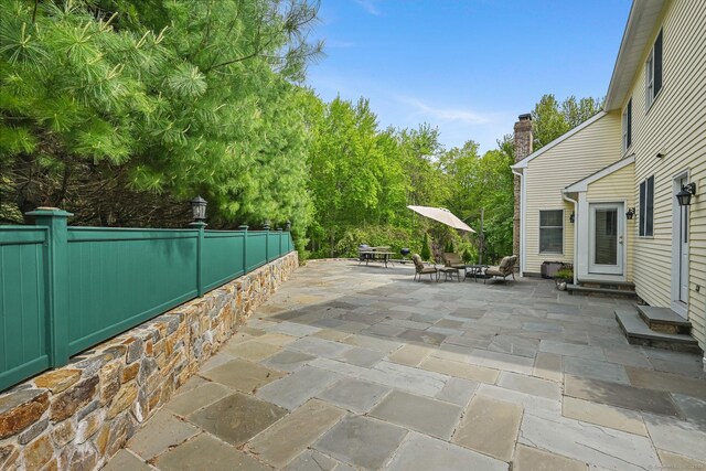 260 Range Rd, Fairfield, CT 06890 - view of patio featuring fence, entry steps, and view of wooded area