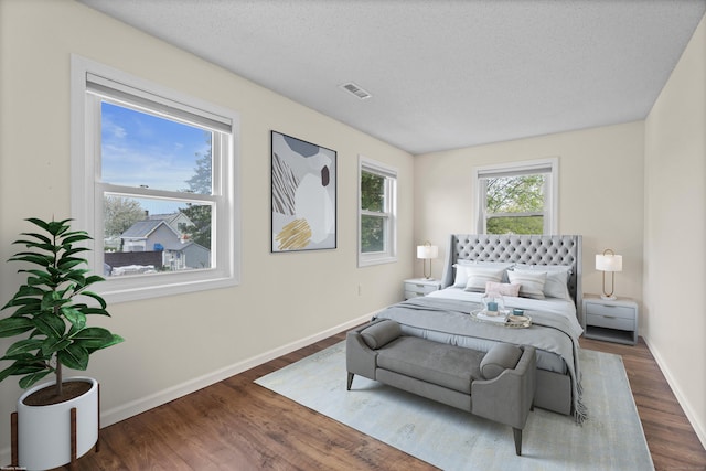 bedroom with wood finished floors and baseboards