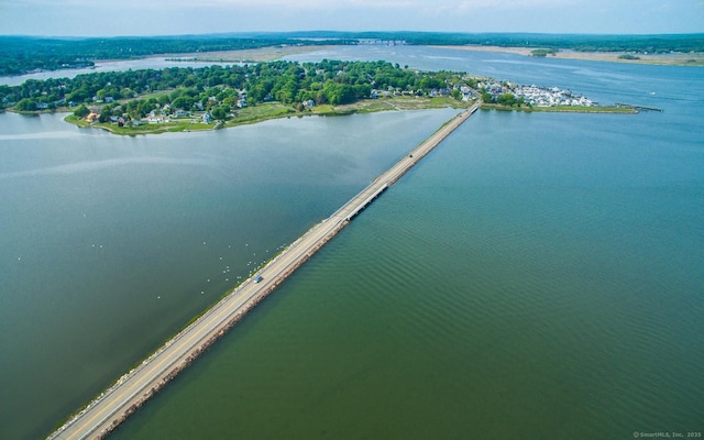 aerial view of property and surrounding area featuring a nearby body of water