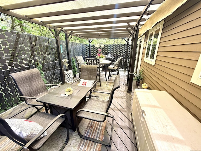 wooden deck with a fenced backyard, a pergola, and outdoor dining space