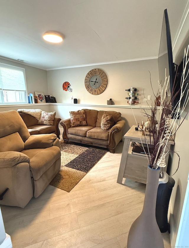 living room featuring wood finished floors and ornamental molding