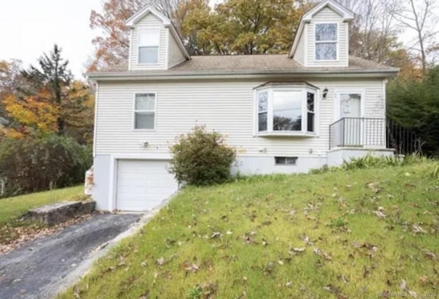 exterior space with a yard, a garage, and driveway