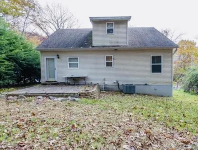 rear view of property with cooling unit and a patio area