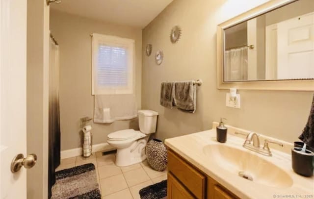 bathroom featuring toilet, tile patterned floors, and vanity