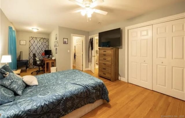 bedroom with light wood finished floors, a closet, and ceiling fan
