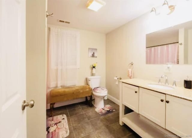 bathroom with toilet, visible vents, curtained shower, tile patterned floors, and vanity