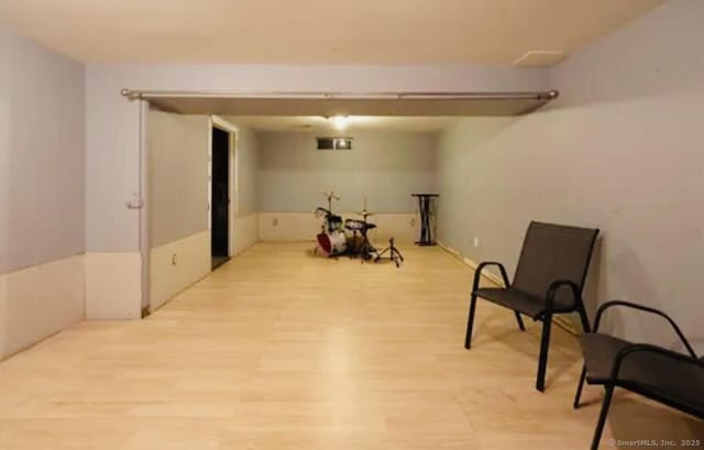 finished basement featuring light wood-type flooring