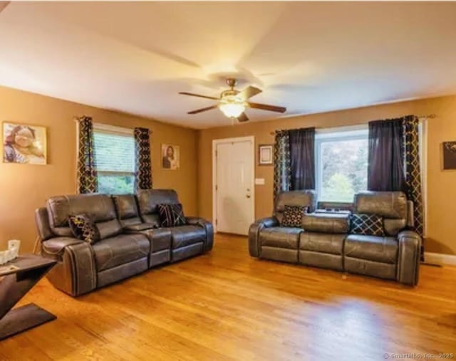 living room with light wood finished floors and a healthy amount of sunlight