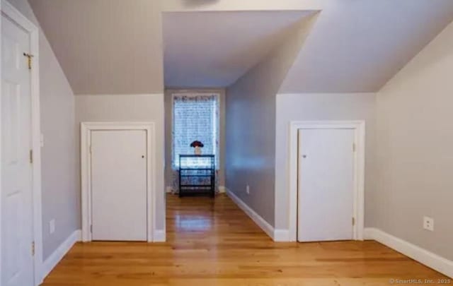 bonus room featuring baseboards and light wood-type flooring