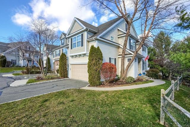 view of side of home with asphalt driveway, an attached garage, and a residential view