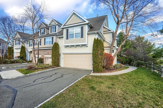 view of front of home featuring asphalt driveway and an attached garage