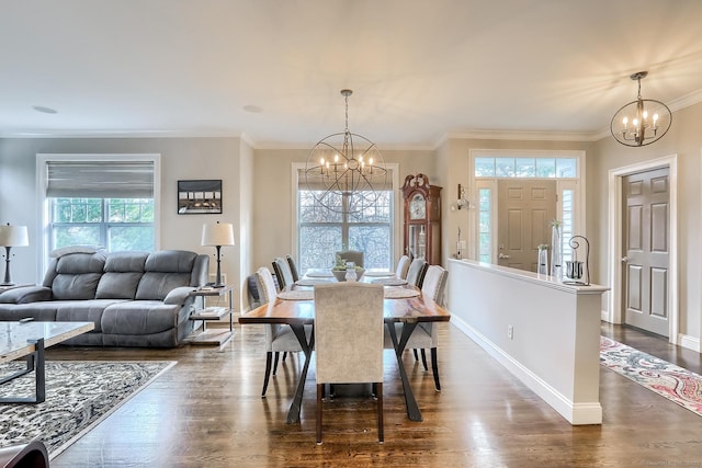 dining room with a chandelier, crown molding, dark wood finished floors, and baseboards