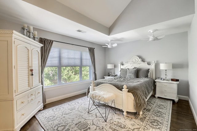 bedroom featuring lofted ceiling, baseboards, and dark wood-type flooring