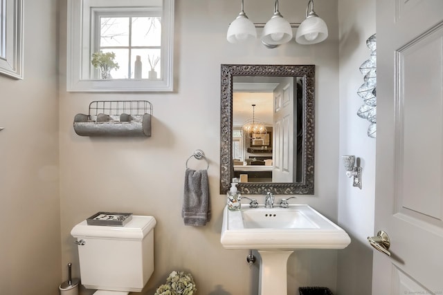 half bathroom with toilet and a sink