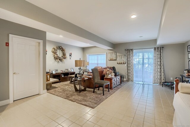 living room with light tile patterned flooring and recessed lighting