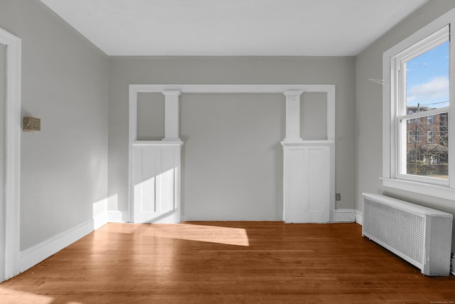 143 Putnam St, Hartford, CT 06106 - spare room featuring radiator heating unit and wood finished floors