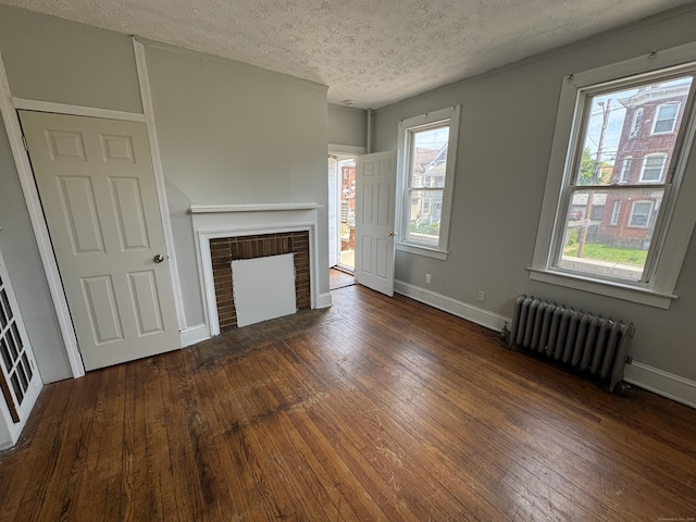 143 Putnam St, Hartford, CT 06106 - unfurnished living room with a textured ceiling, baseboards, radiator, hardwood / wood-style floors, and a fireplace