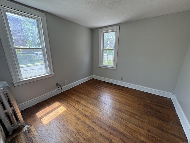 143 Putnam St, Hartford, CT 06106 - empty room with a textured ceiling, baseboards, and wood-type flooring