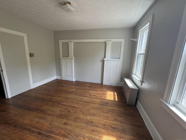 143 Putnam St, Hartford, CT 06106 - unfurnished room featuring a textured ceiling, wood finished floors, and radiator heating unit