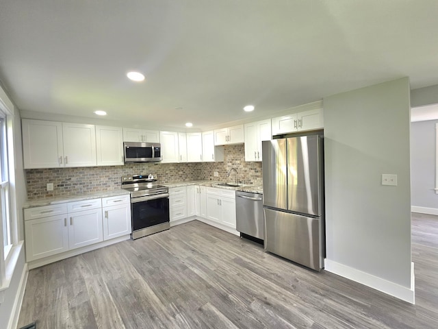 1 Arlington Hts, Norwich, CT 06360 - kitchen with stainless steel appliances, a sink, tasteful backsplash, light wood-style flooring, and white cabinets