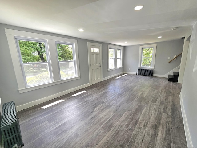 1 Arlington Hts, Norwich, CT 06360 - unfurnished living room featuring wood finished floors, stairs, radiator heating unit, baseboards, and recessed lighting