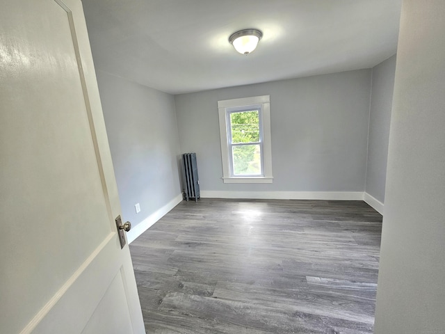 1 Arlington Hts, Norwich, CT 06360 - spare room with radiator, wood finished floors, and baseboards