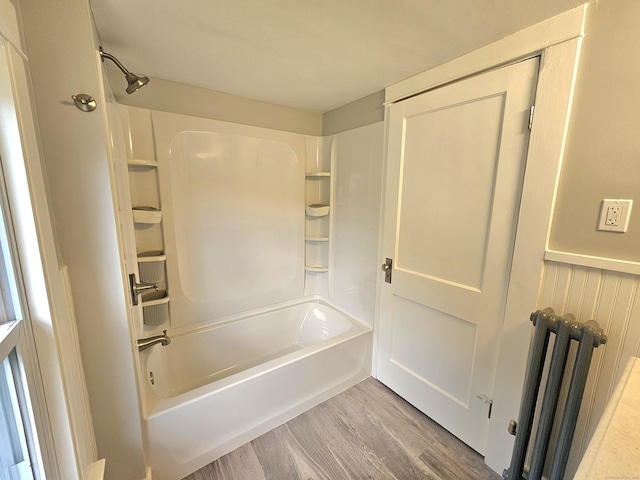 1 Arlington Hts, Norwich, CT 06360 - bathroom featuring wood finished floors, radiator, and tub / shower combination