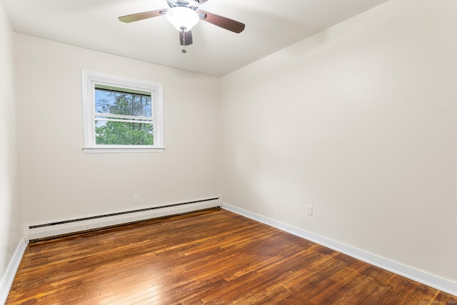 unfurnished room featuring baseboard heating, hardwood / wood-style flooring, and baseboards