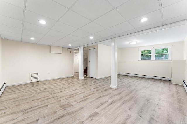 below grade area featuring a baseboard radiator, wood finished floors, baseboards, and recessed lighting