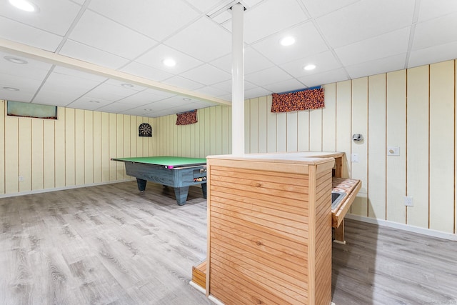 rec room featuring a paneled ceiling, billiards table, light wood finished floors, wood walls, and baseboards