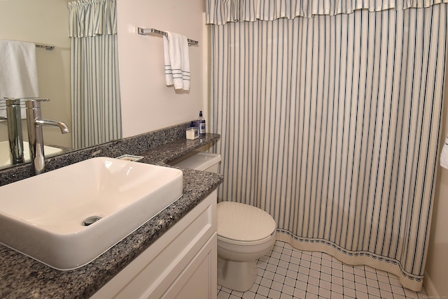 full bathroom with tile patterned floors, toilet, and vanity