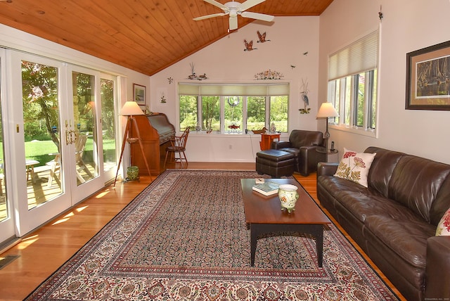 living area with wooden ceiling, french doors, plenty of natural light, wood finished floors, and high vaulted ceiling