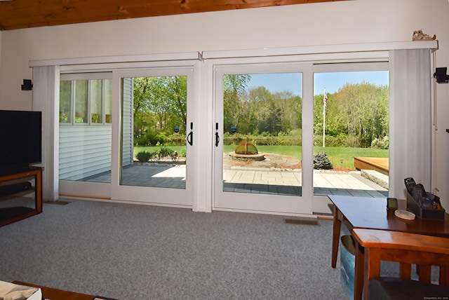 entryway with healthy amount of natural light and carpet flooring