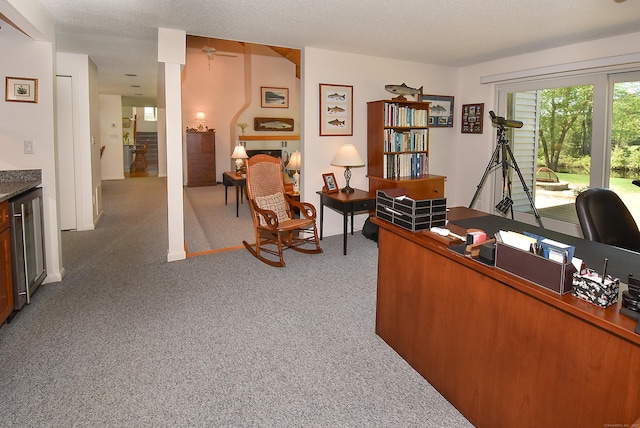 office space with light colored carpet, wine cooler, and a ceiling fan