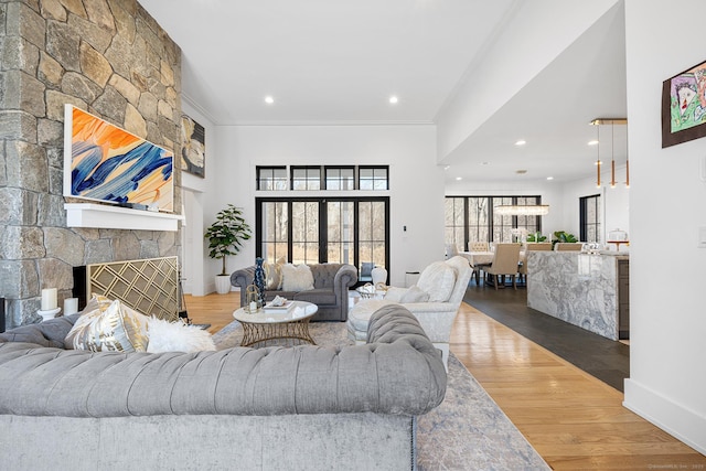 100 Georgetown Rd, Weston, CT 06883 - living area featuring wood finished floors, recessed lighting, baseboards, a stone fireplace, and ornamental molding