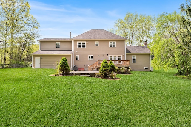 rear view of property featuring a deck and a chimney