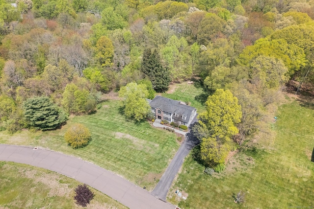 aerial view of property and surrounding area with a forest