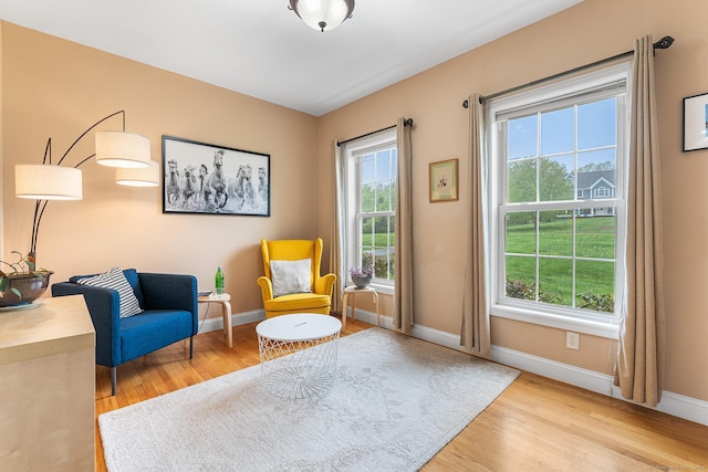 living area with wood finished floors and baseboards