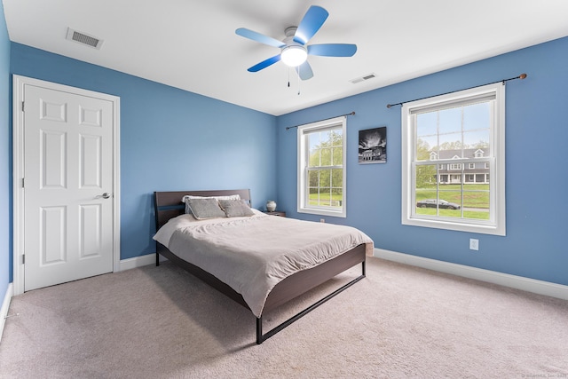 bedroom featuring baseboards, carpet flooring, and a ceiling fan