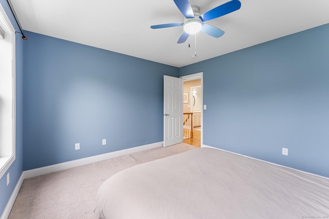 unfurnished bedroom with carpet flooring, baseboards, and a ceiling fan